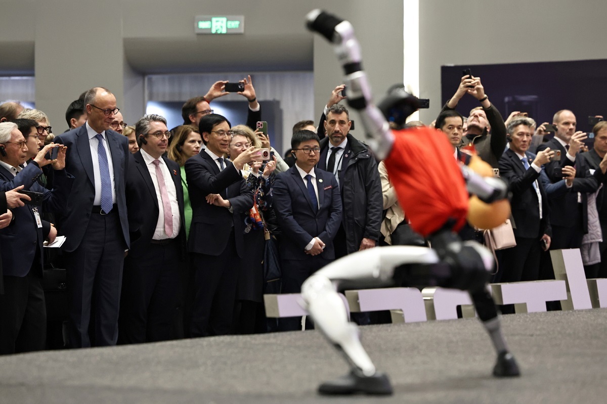 A show of dancing robots. Beijing showed Merz its strength