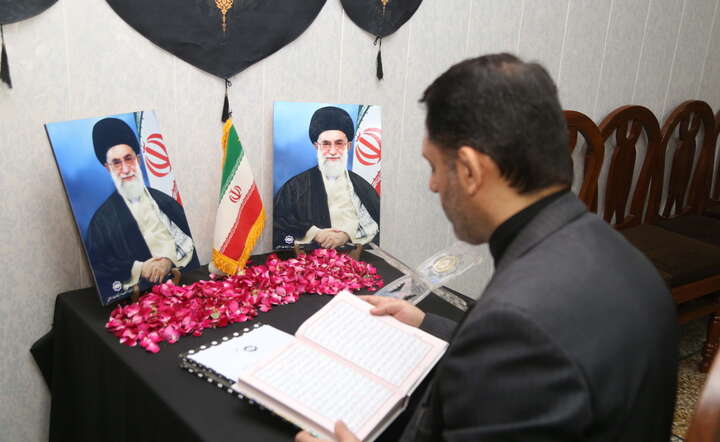 W Iranie ogłoszono 40-dniową żałobę po śmierci ajatollaha Chamenei. Nz. mężczyzna czyta Koran przed ołtarzykiem z wizerunkami ajatollaha / autor: PAP/EPA/NADEEM KHAWER