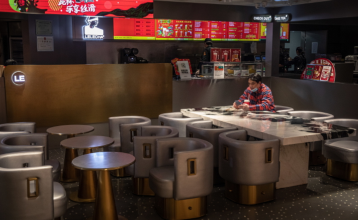 Mężczyzna w masce ochronnej  w pustej restauracji w centrum handlowym, w dzielnicy Central Business District  w Pekinie, Chiny, 21 lutego 2020 r. / autor: PAP/EPA/ROMAN PILIPEY