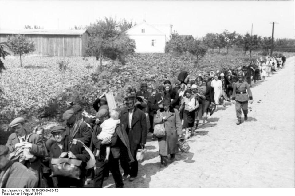 Wysiedleńcy pędzeni pieszo do obozu przejściowego Dulag 121 w Pruszkowie, sierpień 1944 r. / autor: Wikimedia Commons - Bundesarchiv, Bild 101I-695-0423-12 / Leher / Creative Commons Attribution-Share Alike 3.0 Germany