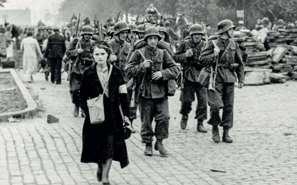 Dziewczyna z Obrony Przeciwlotniczej, w tle polscy żołnierze w starych niemieckich hełmach / autor: Fot. z książki